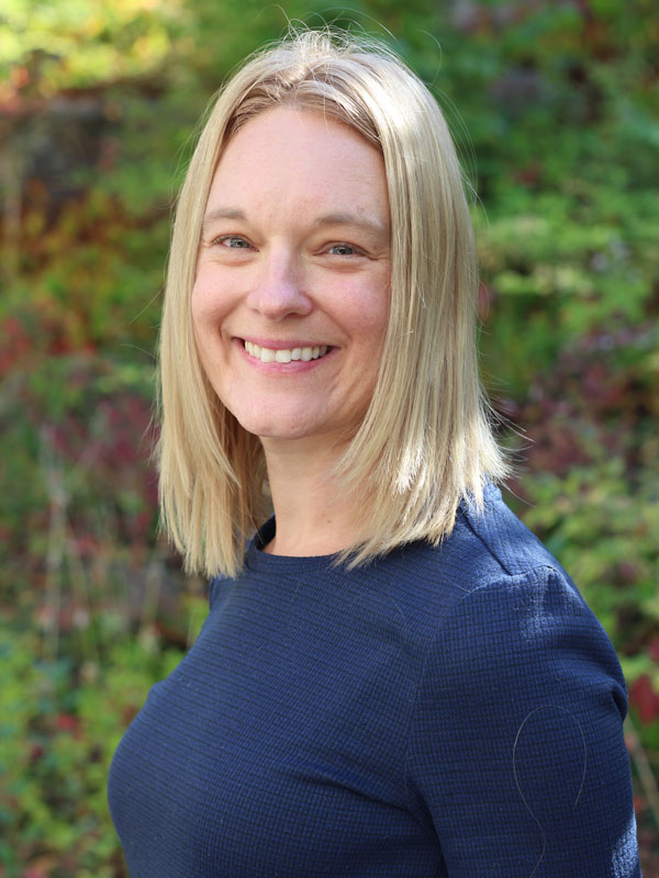 Dawn Jones - a smiling woman with straight blonde hair wearing a dark blue top