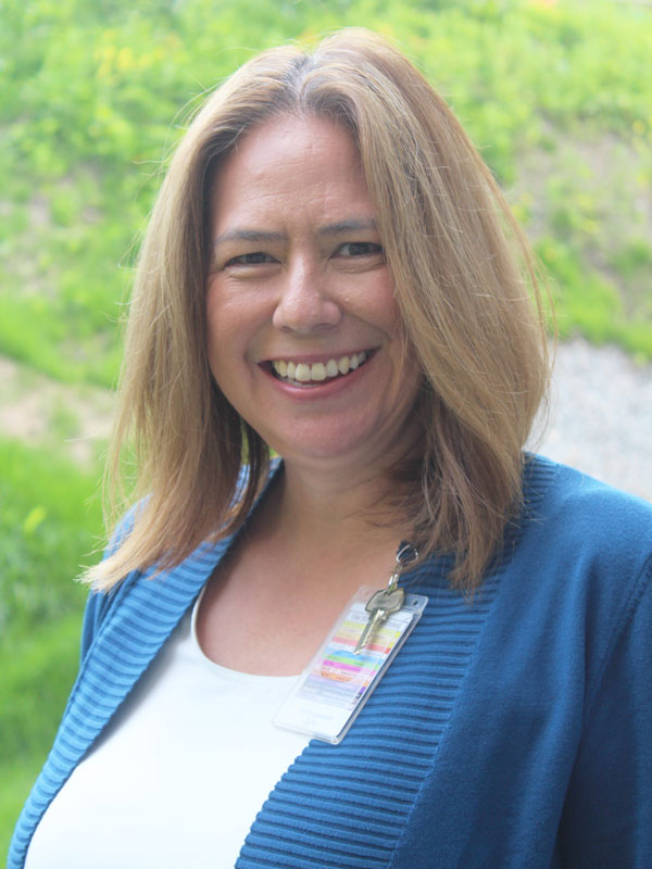 Julianne Labelle - a women with reddish blonde hair wearing a white t-shirt with a blue sweater