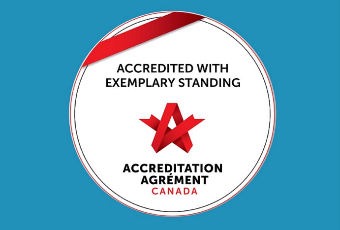 A circle with the words Accredited With Exemplary Standing and a red ribbon on a blue background.