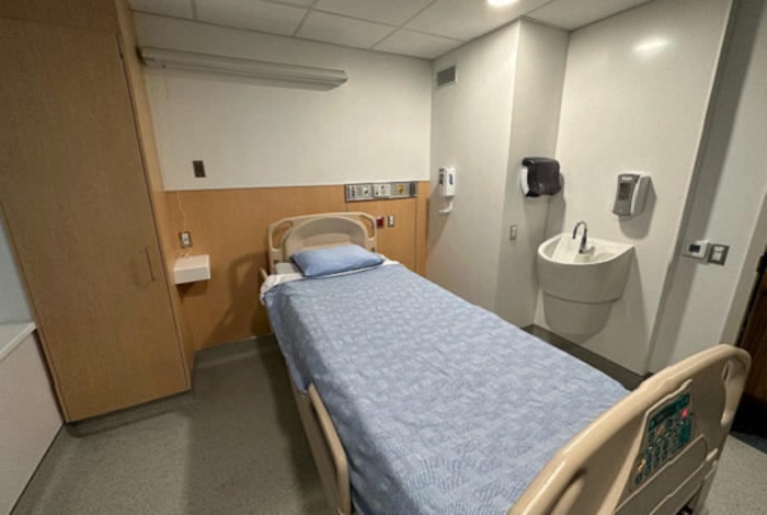 Hospital room showing bed, sink and closet