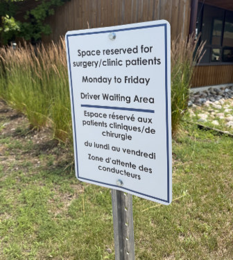 Closeup of the surgery parking sign, saying that the Space is reserved for surgery/clinic patients Monday to Friday